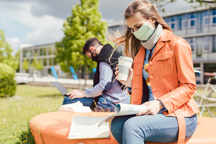 students on campus wearing a face mask