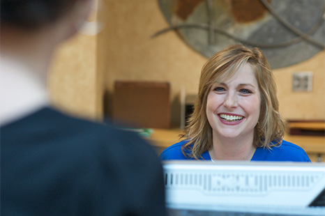 Medical administration staff person assisting a patient