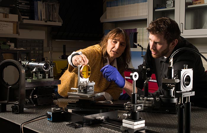 A professor and a student working on a project for an industry partner.