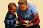 University student reading with child