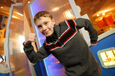 children's hospital patient flexes his muscles