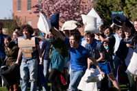 Students having a pillow fight on the quad