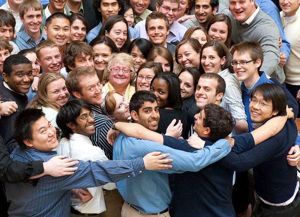 large group of students hugging and smiling