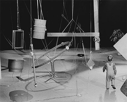 little boy onstate with suspended items like steel drums