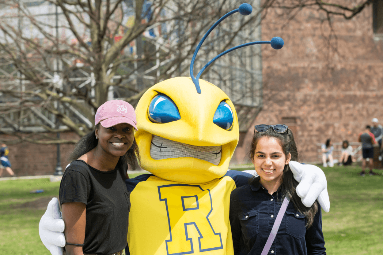 University of Rochester mascot, Rocky, with two students