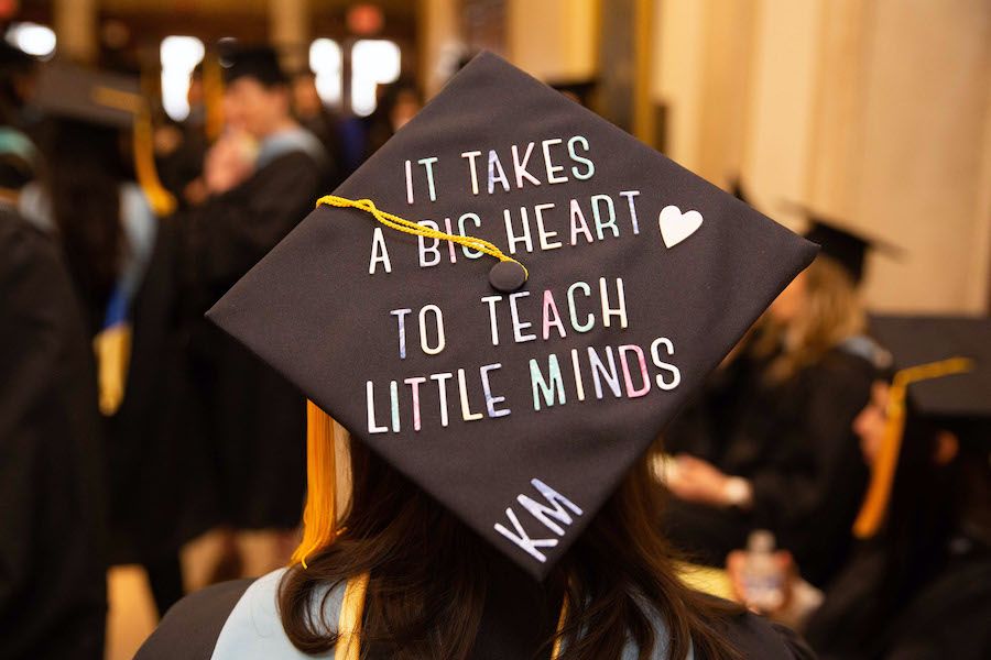 A Warner School of Education student's graduation cap, decorated to read, It takes a big heart to teach little minds.