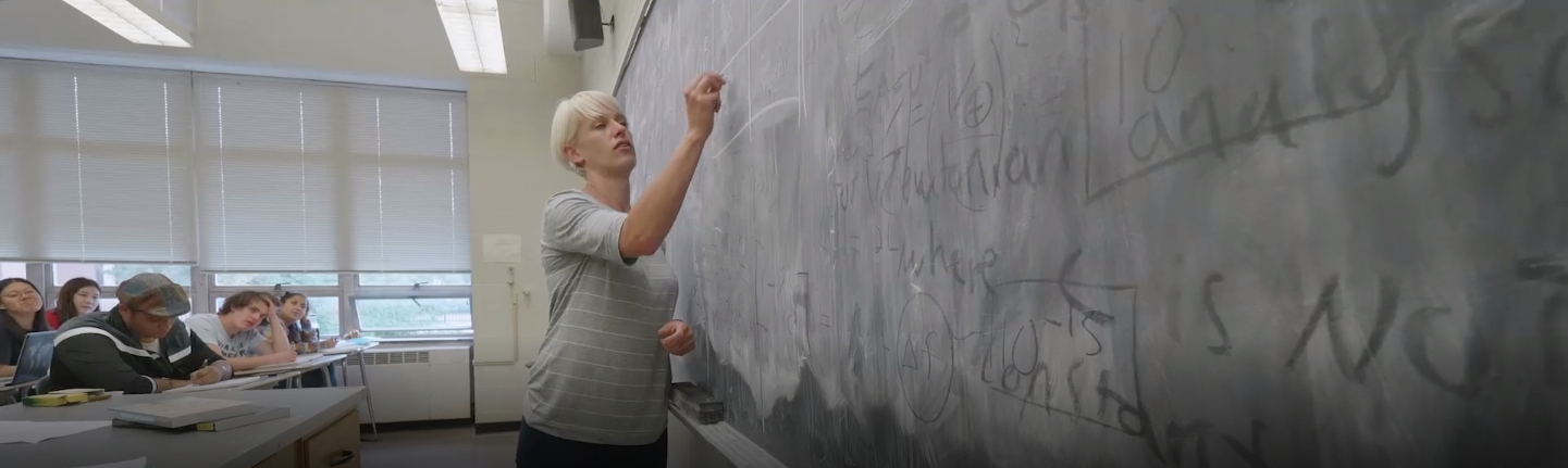 professor writing on a blackboard