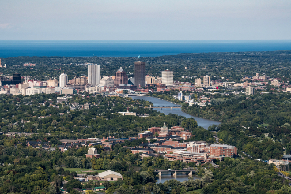 Aerial image of University of Rochester with Rochester skyline in background