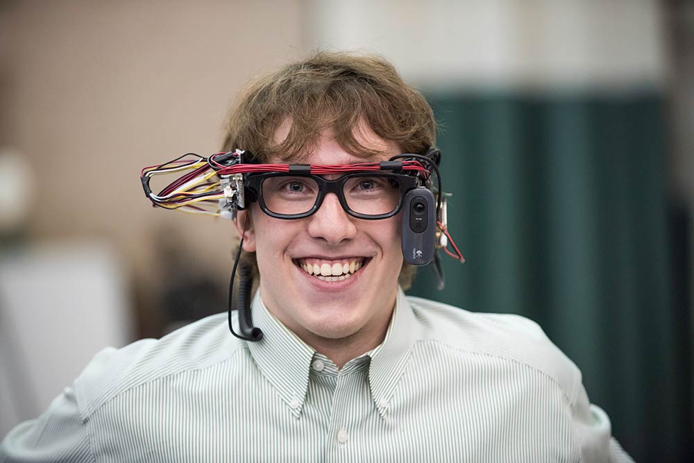 Student smiles while wearing VR goggles