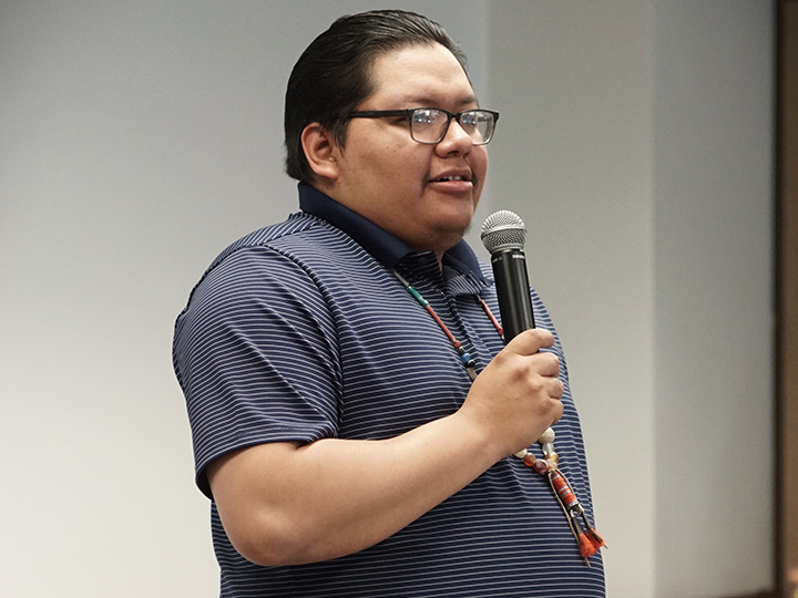 A person speaking into a microphone.