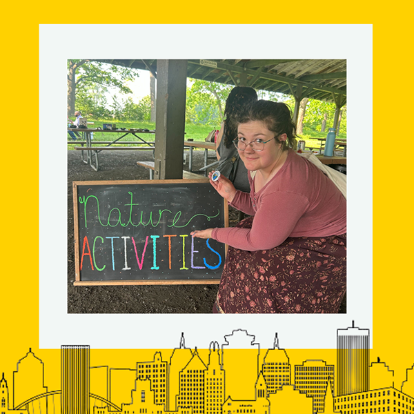 The recipient smiling at the camera with a thick yellow border around the image.