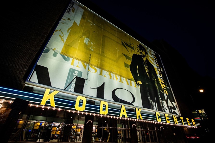 The Kodak Center sign lit up at night.