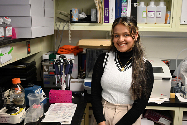 A University of Rochester student prepares her workspace in the lab.