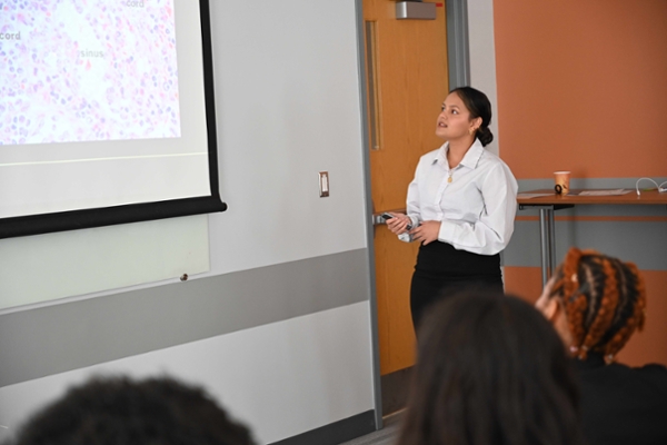 McNair Program scholar Lalita Dahal presents her research on splenic diffuse red pulp lymphoma to her peers at the David T. Kearns Center Summer Research Symposium in July. Photo: Alexa Olson