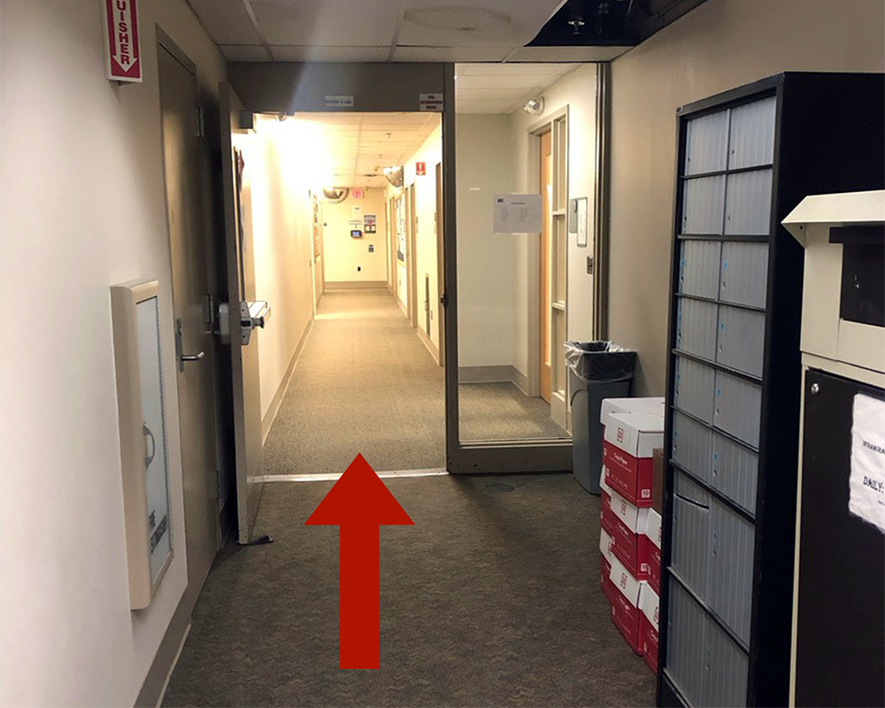 A red arrow points down a short hallway.