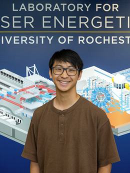 Jeremy smiling in front of a sign. 