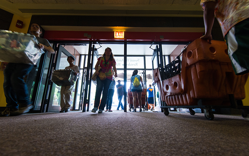 Photo of students entering and exiting Susan B. Anthony Residence Halls on a previous move-in day