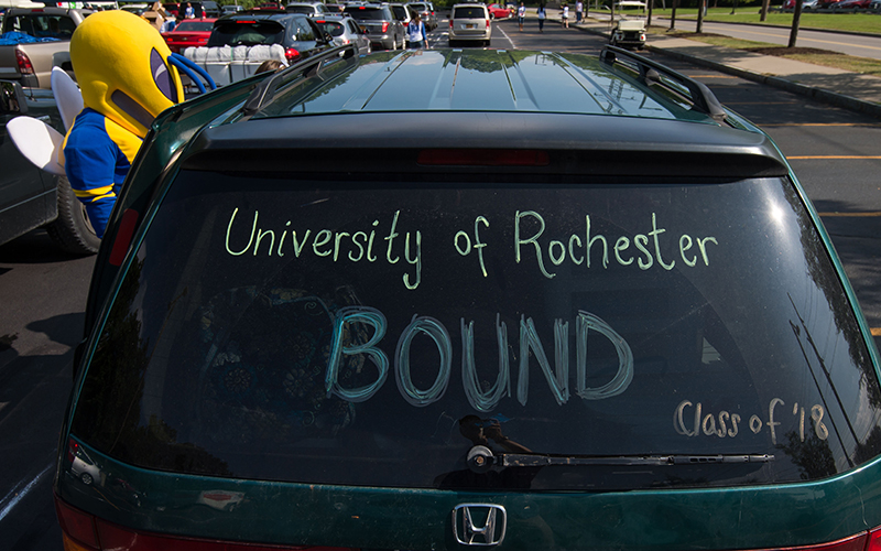 Photo of a van window that has writing on it that reads University of Rochester bound Class of 18