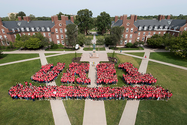 Class of 2021 students pose in the shape of the underlined letters and number UR 21 on Wilson Quad
