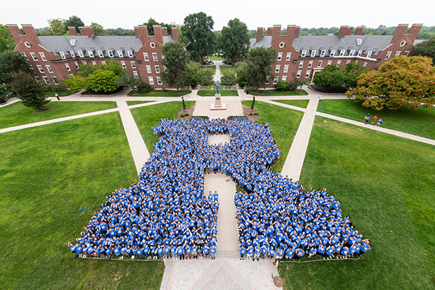Class of 2022 students pose in the shape of an R on Wilson Quad
