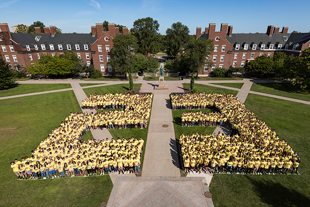 Class of 2023 students pose in the shape of the number 23 on Wilson Quad
