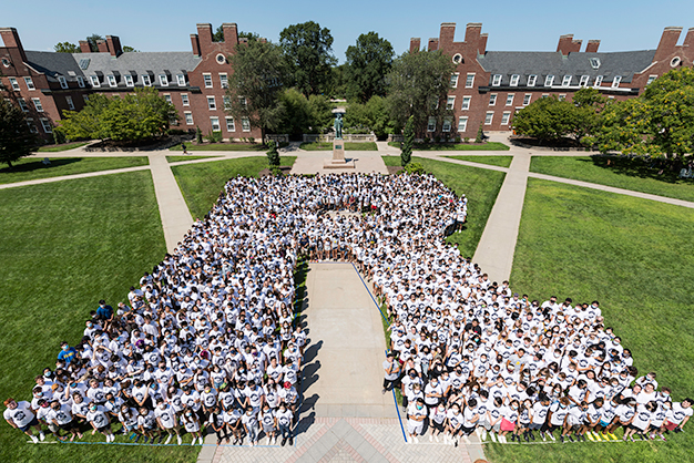Class of 2025 students pose in the shape of an R on Wilson Quad