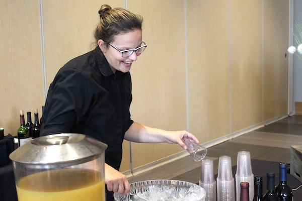 Woman smiling while scooping ice into a cup