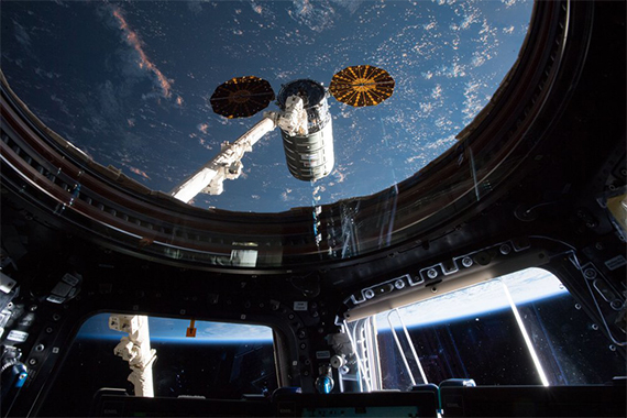 A view from inside the International Space Station looking outward at the Earth.