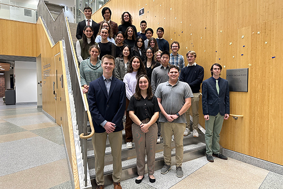 New initiates of the Tau Beta Pi engineering honor society pose on a staircase