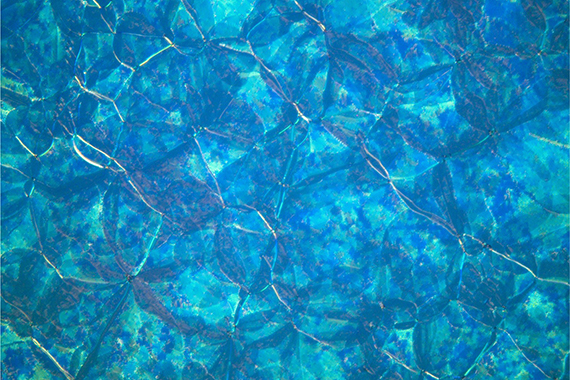 An optical microscope image of a blue amorphous material that crystallized under abnormal conditions.