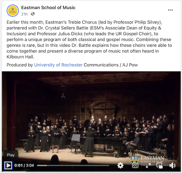 Screenshot of the Eastman School of Music Facebook page showing a wide shot of two large choirs in black robes on a stage