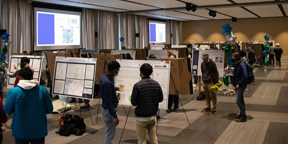 Graduate students deliver poster presentations in Feldman Ballroom.