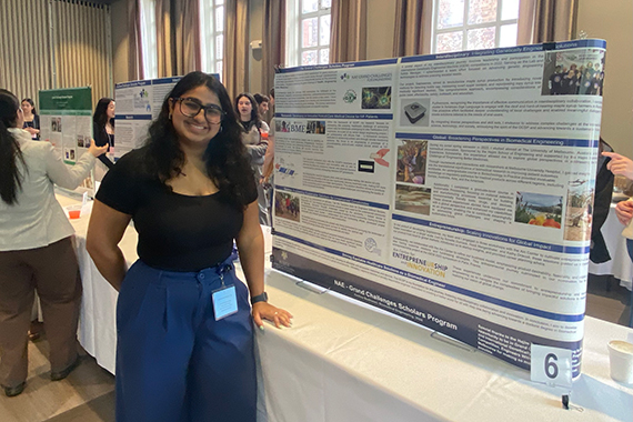 Biomedical engineering student Aashee Budhwani stands beside her poster at the Undergraduate Research Expo.