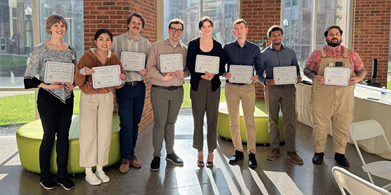 A group shot of students recognized at the “One Page PhD Policy Pitch” competition, including James Spann, second from the right.