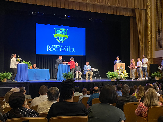 A student accepts a ring during an Order of the Engineer ceremony at Strong Auditorium.