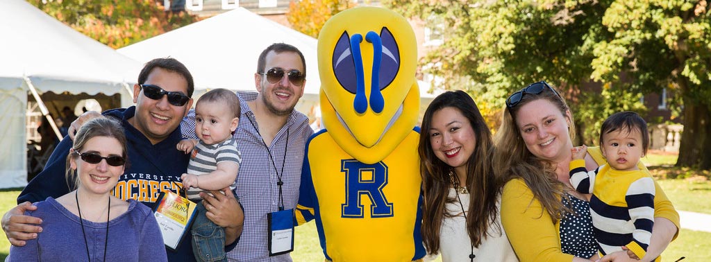crowd poses with Rocky mascot