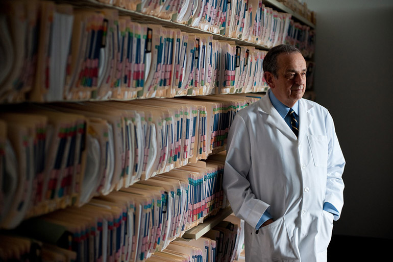 doctor standing in front of files