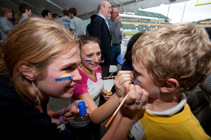 student painting a child's face