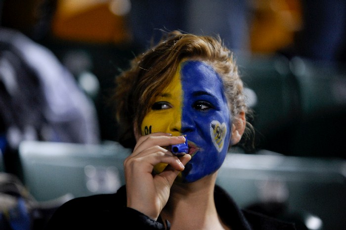 girl with painted face playing kazoo