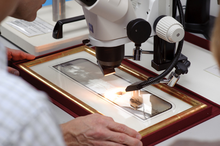 microscope hovering over daguerreotype