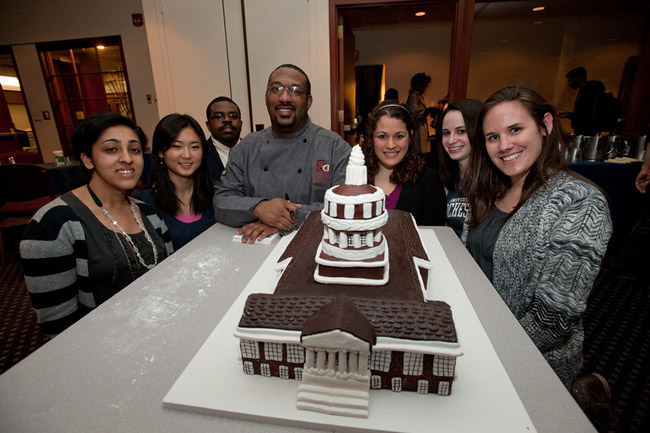 Dana Herbert poses with students and cake