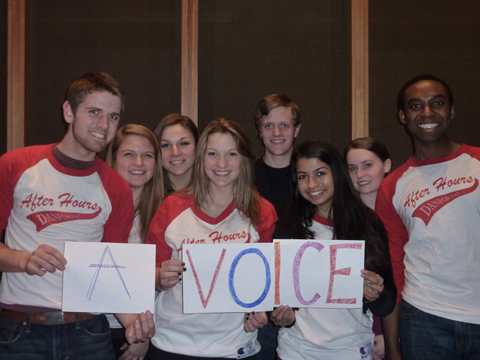 student holding sign that reads A VOICE