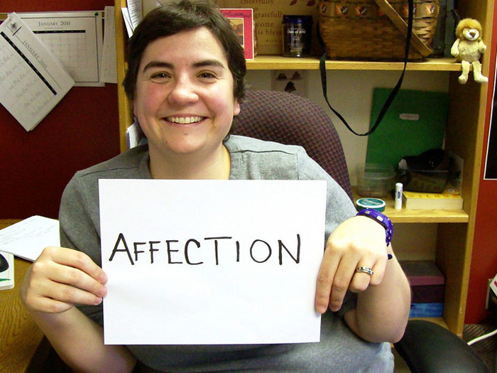 student holding sign that reads AFFECTION