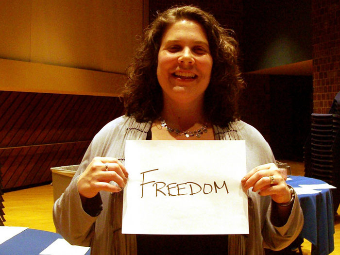 student holding sign that reads FREEDOM