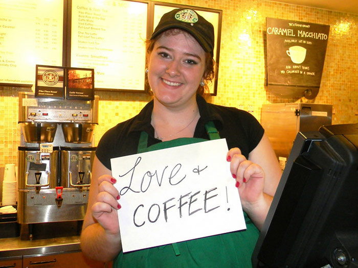 student holding sign that reads LOVE AND COFFEE