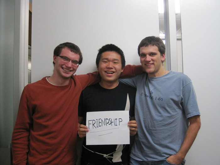 student holding sign that reads FRIENDSHIP