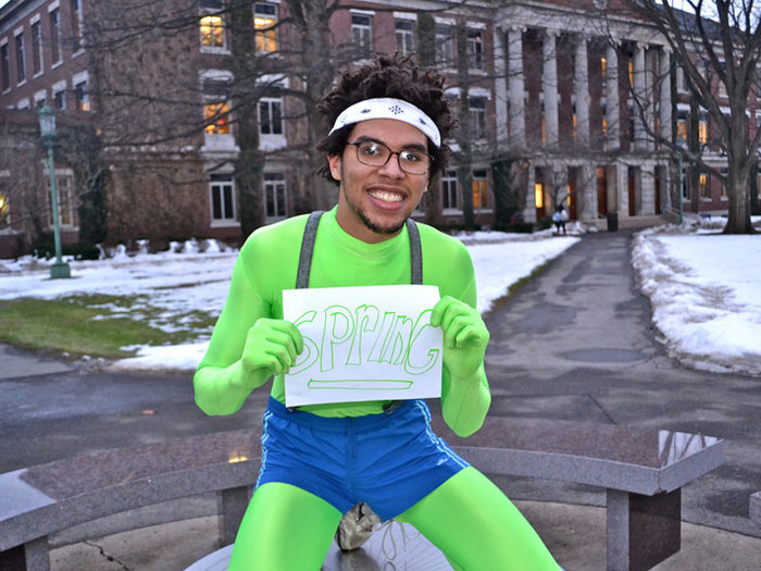 student holding sign that reads SPRING