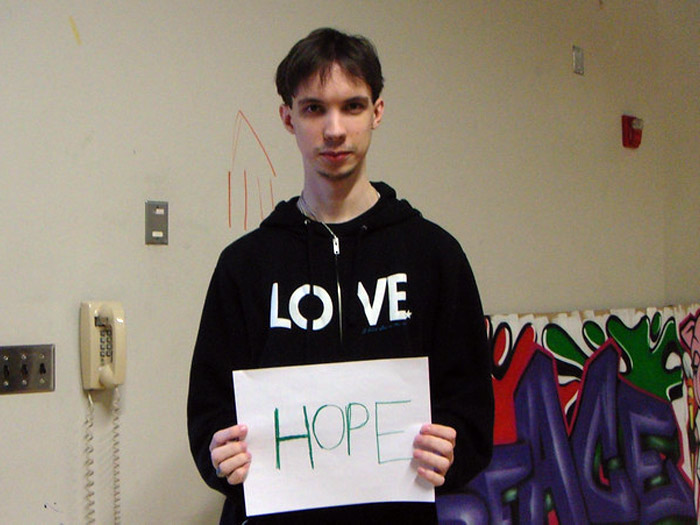 student holding sign that reads HOPE