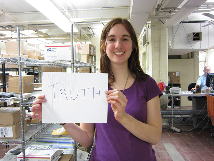 student holding sign that reads TRUTH