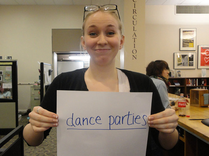 student holding sign that reads DANCE PARTIES